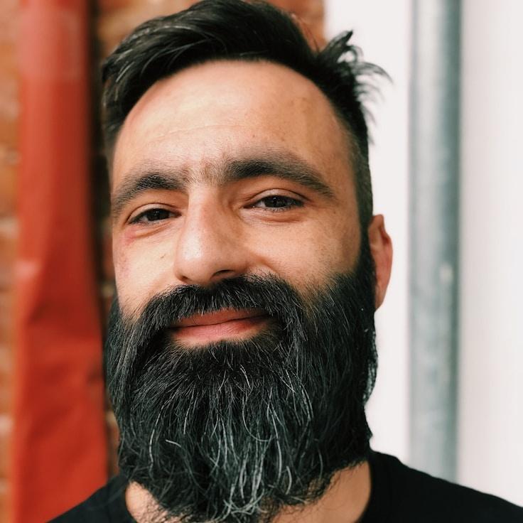 Ava Singh, Lead Design Curator at NeutralClarityNetwork, reviewing corporate floral arrangements